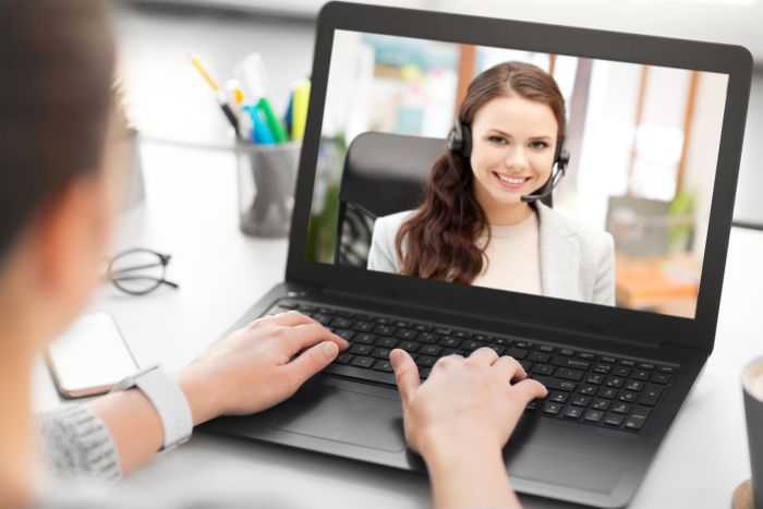 woman having video call on laptop at office